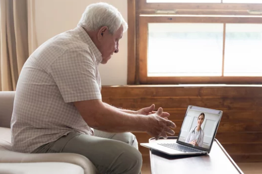 Adult reviewing a B12 injection kit at home while talking to a clinician online